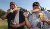 These two enthusiasts enjoy traditional corn-on-the-cob at the Lemoore Lions annual Brewfest Saturday at Lemoore Lions Park.